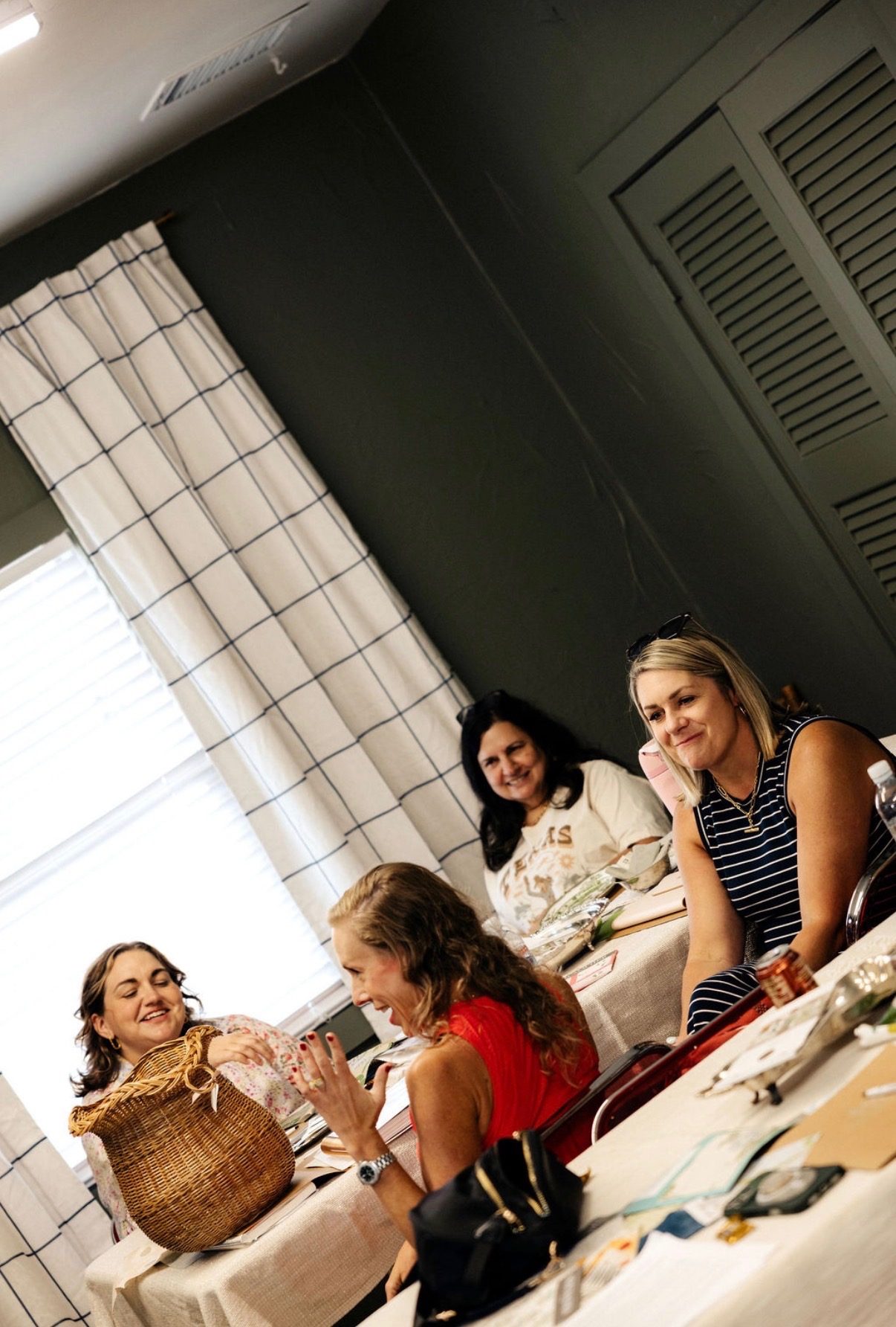Design Camp guests laughing together around the table