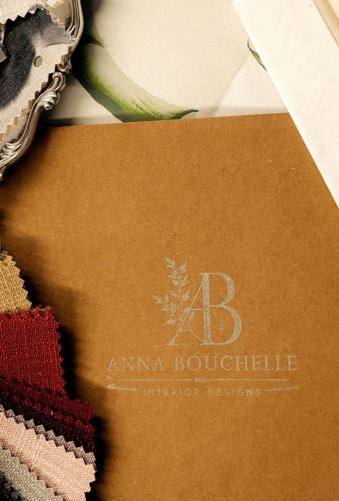An Anna Bouchelle kraft folder with fabric swatches from camp